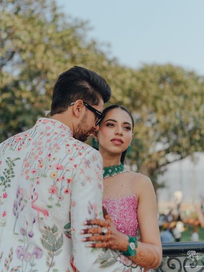 A candid and intimate moment. The groom whispers to the bride, whose gaze is directed away, creating a sense of a private world between the two of them.