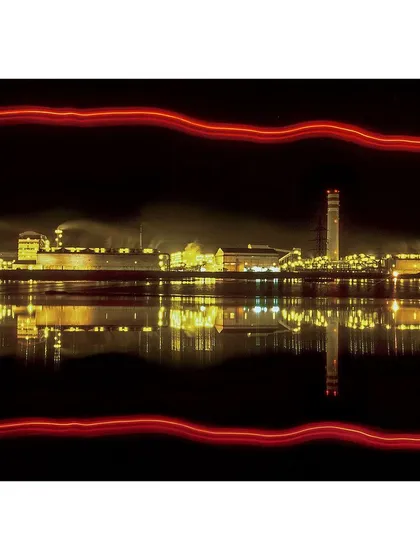 This image demonstrates my creative approach to industrial photography. Using a slow shutter speed, I captured the factory's reflection and added light trails to create a dynamic and artistic composition that goes beyond simple documentation.