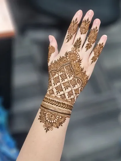 A focus on the geometric cuff design, which features a beautiful lattice pattern and leafy border.