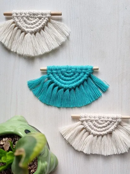 These small, fan-shaped macrame hangings are made from scrap cords, ensuring nothing goes to waste. They are great as ornaments or small decorative accents.