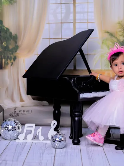 A little princess meets a grand piano in this elegant setup. We combine our 'Mini Musician' theme with a touch of royalty, complete with a beautiful dress and a tiny crown for a magical baby girl photoshoot.