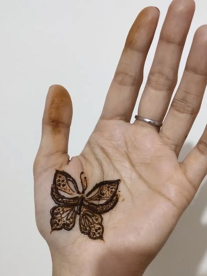 A simple butterfly design in the center of the palm.