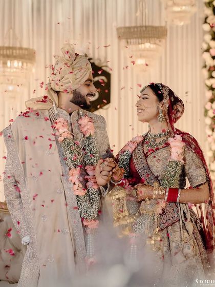 The happy couple, Shelly and Shivam, showered with petals after their Varmala ceremony.
