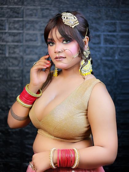 A bold portrait against a dark, textured background, highlighting the model's expressive look.