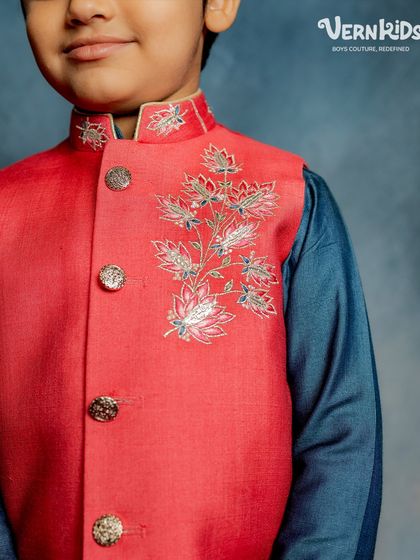 A close-up of our red lotus Bundi. This shot highlights the intricate silver embroidery and elegant buttons, details that make our Jashn Collection pieces so special.