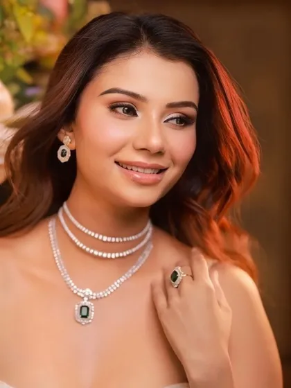 Get ready for gala glam. This eye-catching look features soft, smokey eyes and a nude lip, paired with a stunning white lehenga and diamond jewelry.