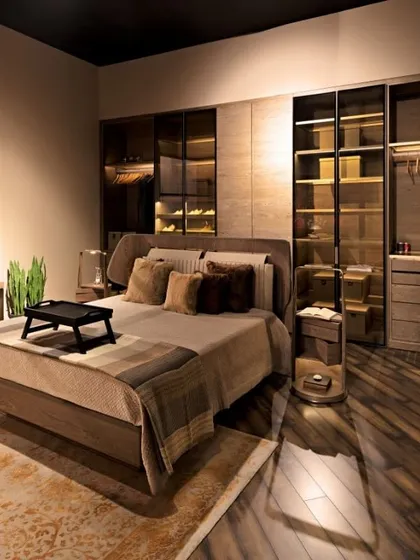This premium bedroom suite is finished in warm, neutral tones using a combination of Succupira veneer and brass matt highlights. The leather upholstery on the bed and study chair adds a final layer of sophisticated style.