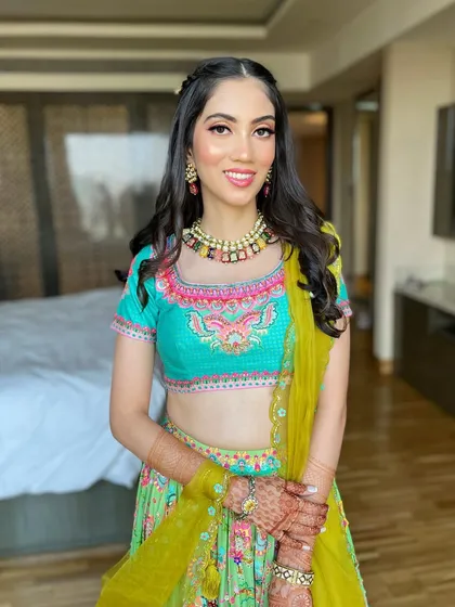 The full look, showing how the soft makeup complements the bright and colorful lehenga.