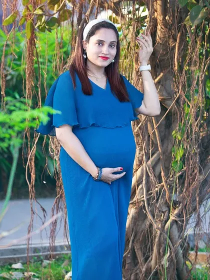 A chic and modern maternity portrait in a royal blue dress. The simple elegance of the dress and the natural pose make this a stunning shot.