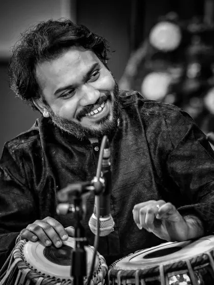 A moment of joy during a concert, captured in black and white. A smile shared with a fellow artist or the audience is a beautiful part of any performance.