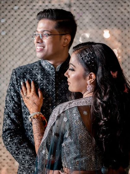 A modern and stylish couple portrait. I focus on capturing the couple's connection and individual style against a clean, lit background.