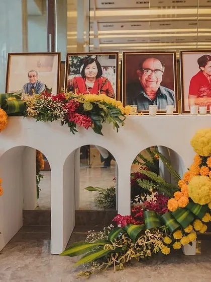A special corner dedicated to honoring the family's elders. The table is beautifully decorated with a cascade of marigolds and other fresh flowers, adding a personal and emotional touch to the event.