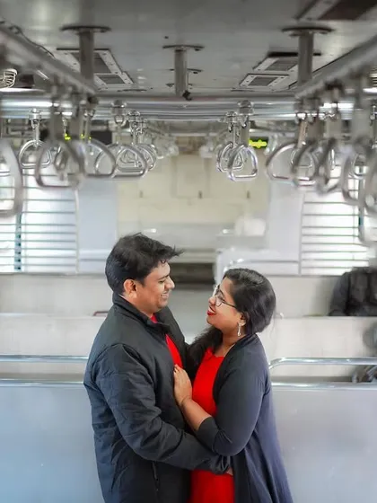 A classic portrait inside a Mumbai local train. The symmetry of the handrails and the authentic environment create a unique backdrop for a modern love story.
