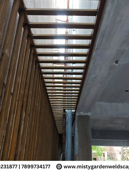 A strong and stylish safety grill installation in RR Nagar. This design uses vertical metal bars to provide maximum security for a narrow passage while allowing light and air to pass through.
