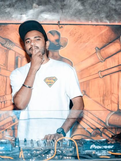 A moment of quiet confidence at the decks. It's about being authentic and letting the music speak for itself.