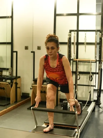 The intensity of Pilates comes from control, not momentum. This client showcases the quiet strength that is built through focused, graceful movements on the reformer.