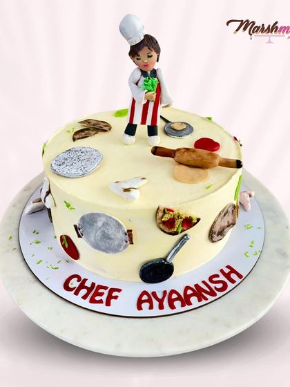 Another angle of the young chef cake, sitting on a marble cake stand. The details are hand-painted to give them a realistic look.
