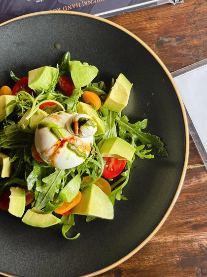 A fresh Avocado and Burrata summer salad. This image is clean and bright, emphasizing the fresh, healthy ingredients perfect for a summer menu feature.