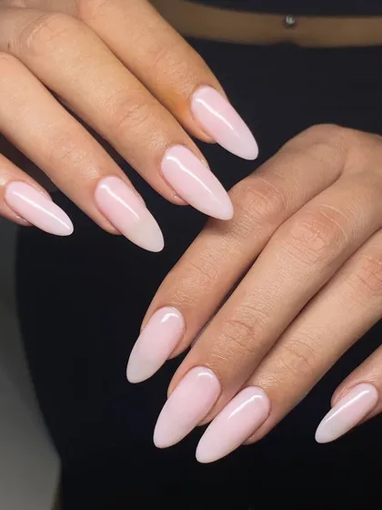 A beautiful set of long, milky pink extensions in an elegant stiletto shape. This look is clean, feminine, and modern.