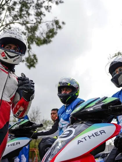 A moment of camaraderie between riders before the start of an EV race. Our events bring together professionals and amateurs who share a passion for motorsport.