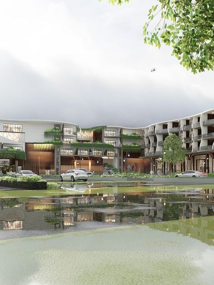 The facade of the Sea Front Business Hotel, designed to thrive in a humid coastal climate. The building's form, with its strategic openings and green terraces, facilitates cross-ventilation while offering guests panoramic sea views.