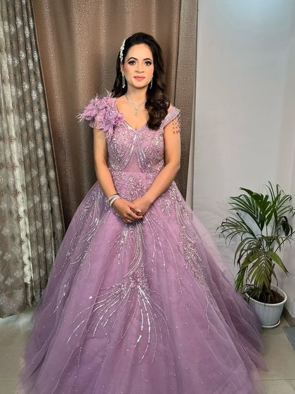 A full-length shot of the bride-to-be in her magnificent lavender ball gown. The overall look is dreamy and princess-like.