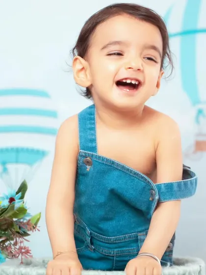 A big, joyful laugh from this little one in our hot air balloon setup.