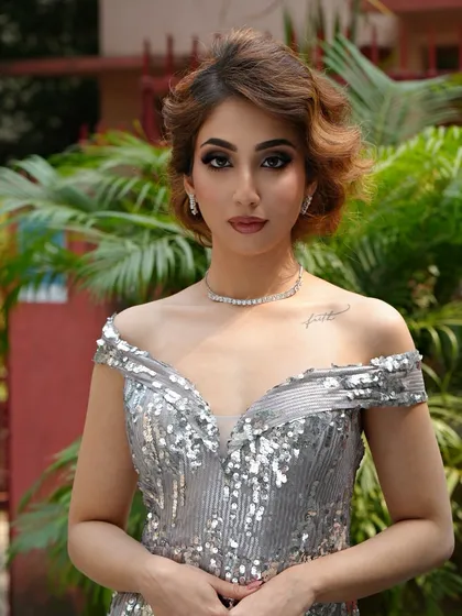 A direct shot of the model, highlighting the expertly applied makeup that is ready for any red carpet event.