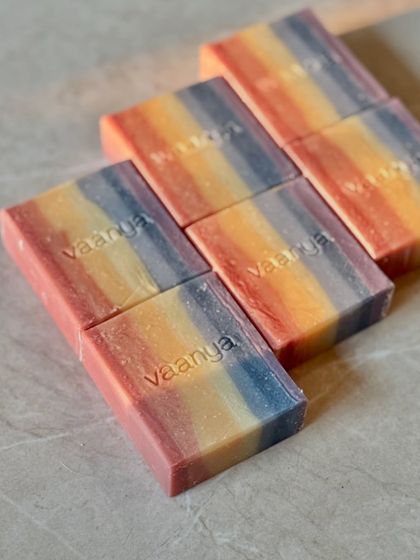 A closer look at our Rainbow Artisan Soaps. Each bar is stamped with our name, a mark of our handmade promise. The layers of color are created using only plant-based clays and powders.