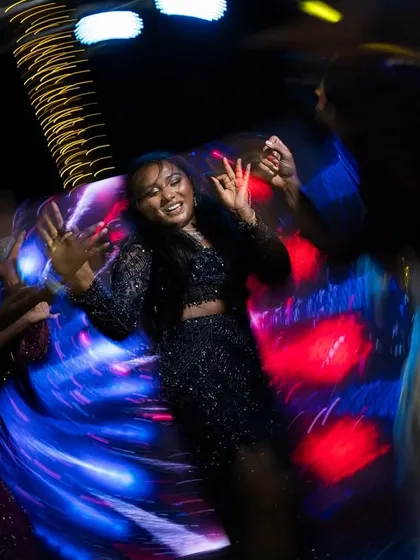 The energy of a Sangeet night captured in a whirlwind of light and motion. I use creative techniques like motion blur to photograph the vibrant spirit of your celebration.