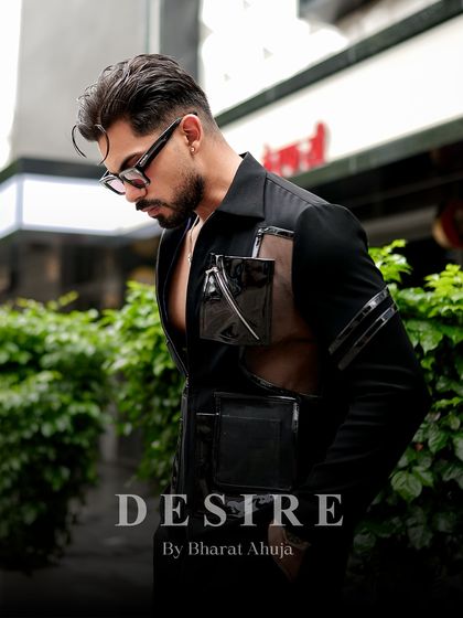 A pensive moment in a powerful shirt. This look is all about confidence, couture, and redefining luxury with every detail.