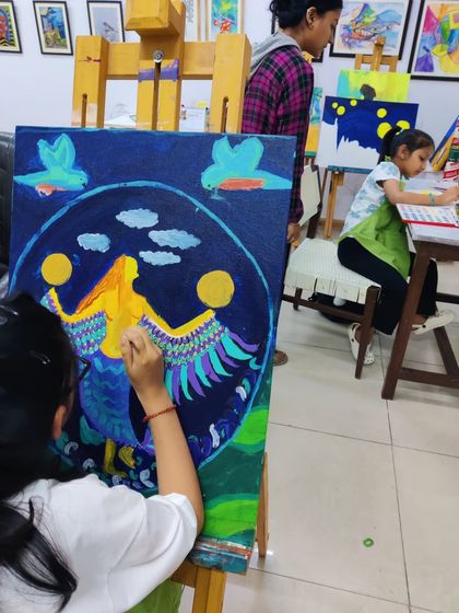 These images document the creation of a whimsical mermaid painting, showing the layering of colors and development of the composition.