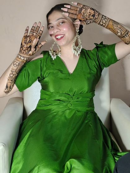 Another playful pose from a happy client, showing off her stunning full-hand mehendi.