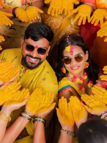 It's not just about the main events. We love capturing the fun of pre-wedding rituals, like this creative and playful group shot during a Haldi ceremony, showcasing the joy shared with family and friends.