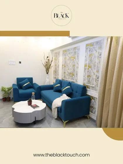 Another view of the living room with the blue sofa set. The textured wall panels and elegant curtains add layers of detail and sophistication to the space.