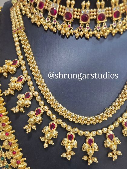 A detailed shot showing the different textures and designs of the layered necklaces in this set.