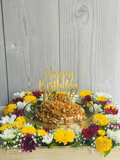 A wider view of the Butterscotch Caramel Tres Leches hamper, showing how the cake and flowers come together to create a complete and thoughtful gift.
