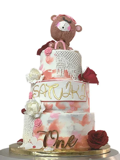 The full view of the magnificent 3-tier Belgian Chocolate cake, designed for a first birthday celebration with the name "Satviki" and the number "One".