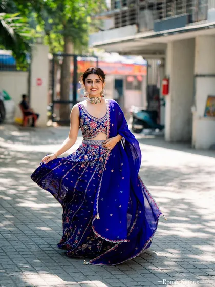 Our client looks absolutely radiant for her mehendi ceremony in this vibrant royal blue lehenga. The intricate floral embroidery and flowing dupatta create a perfect look for a joyful celebration. We help you find pieces that match the energy of your event.