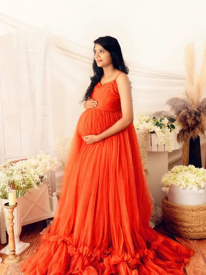 This is for the mom who dreams of a fairytale moment. The vibrant color of the tulle gown against the soft, earthy boho setup creates a beautiful contrast, highlighting her radiant glow.