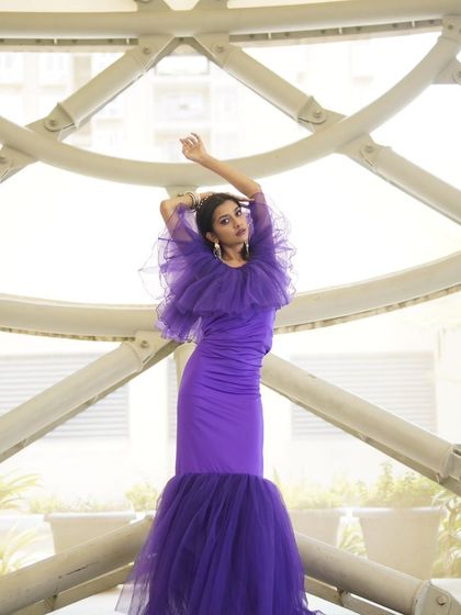 This image shows the power of a full look. The makeup, with its strong eye and glowing skin, works with the architectural background and the dramatic dress to create a high-fashion photograph.