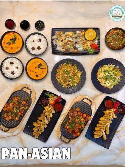 A grand display of our Pan-Asian offerings. This spread includes everything from curries and rice to spring rolls, dumplings, and stir-fried noodles.