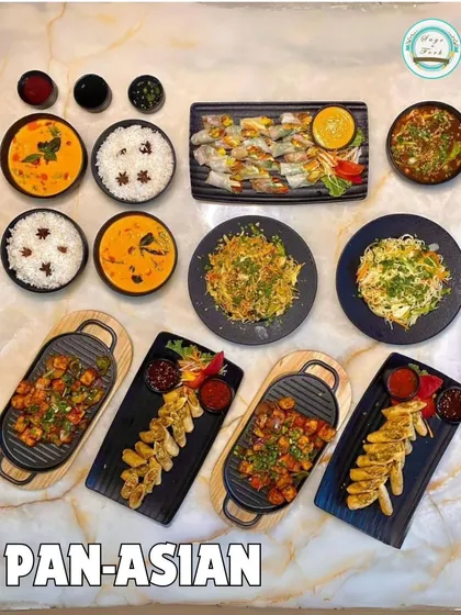 A stunning flat-lay of my Pan-Asian menu. This image shows a wide variety of dishes, from curries and noodles to dumplings and skewers, demonstrating the breadth of my Asian culinary offerings.