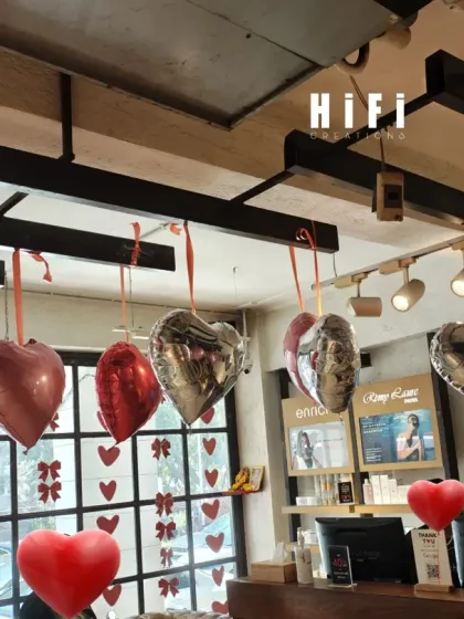 The Valentine's decorations seen from behind the reception desk. The decor is visible from the large front windows, helping to attract customers and communicate the seasonal promotion.
