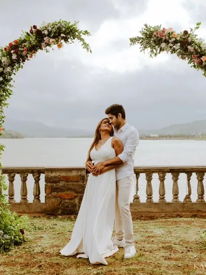 A beautiful pre-wedding portrait session by the lake, framed by a stunning floral arch. I love creating these grand, scenic shots that feel like a fairytale.
