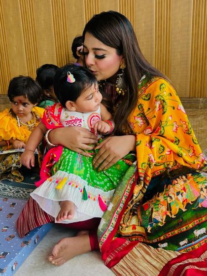 A mother's love during Kanjak puja. Her daughter is dressed in our custom Ganpati-themed lehenga, looking absolutely precious during the ceremony.