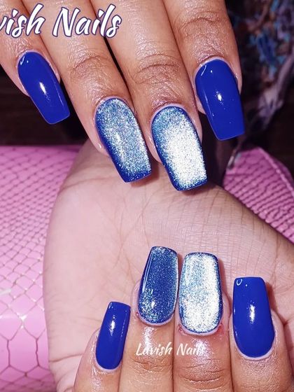A vibrant royal blue set with two accent nails featuring a silver cat-eye effect for a magnetic look.