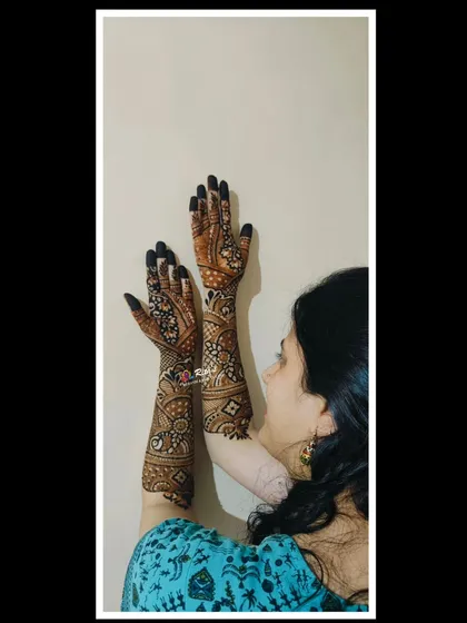 A creative pose showing the beautiful engagement mehendi.
