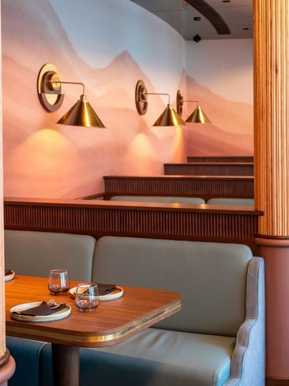 Our booth seating offers the perfect balance of comfort and style, with custom-designed wooden pillars and soft, pastel-toned walls creating a serene dining environment.