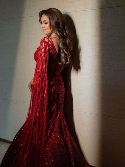 Draped in ruby red and detailed with artistry, this fully embellished lehenga features floor-sweeping sleeves and my signature cutwork embroidery.